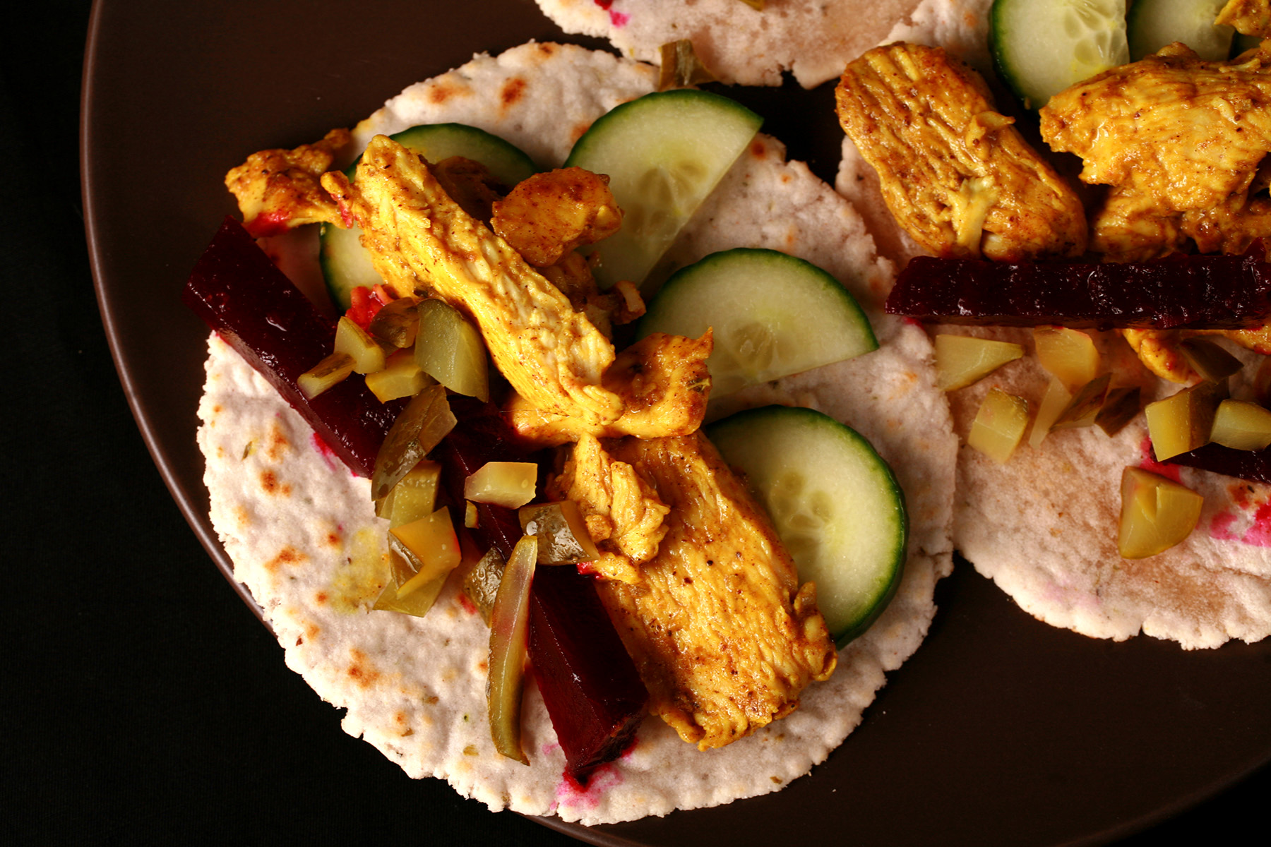 3 cassava tortillas topped with Paleo chicken shawarma, pickled beets, and cucumber slices.