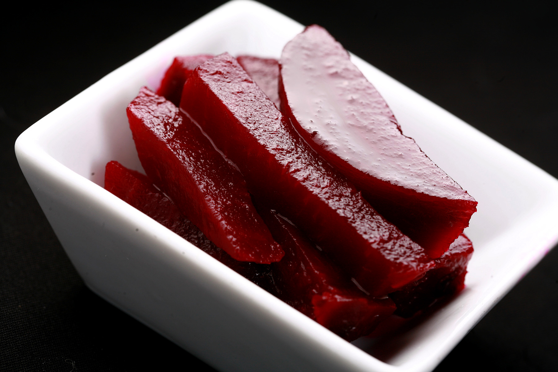 A small white bowl with slices of Paleo Quick Beet Pickles in it.