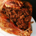 A close up view of a paleo stuffed roasted turkey.