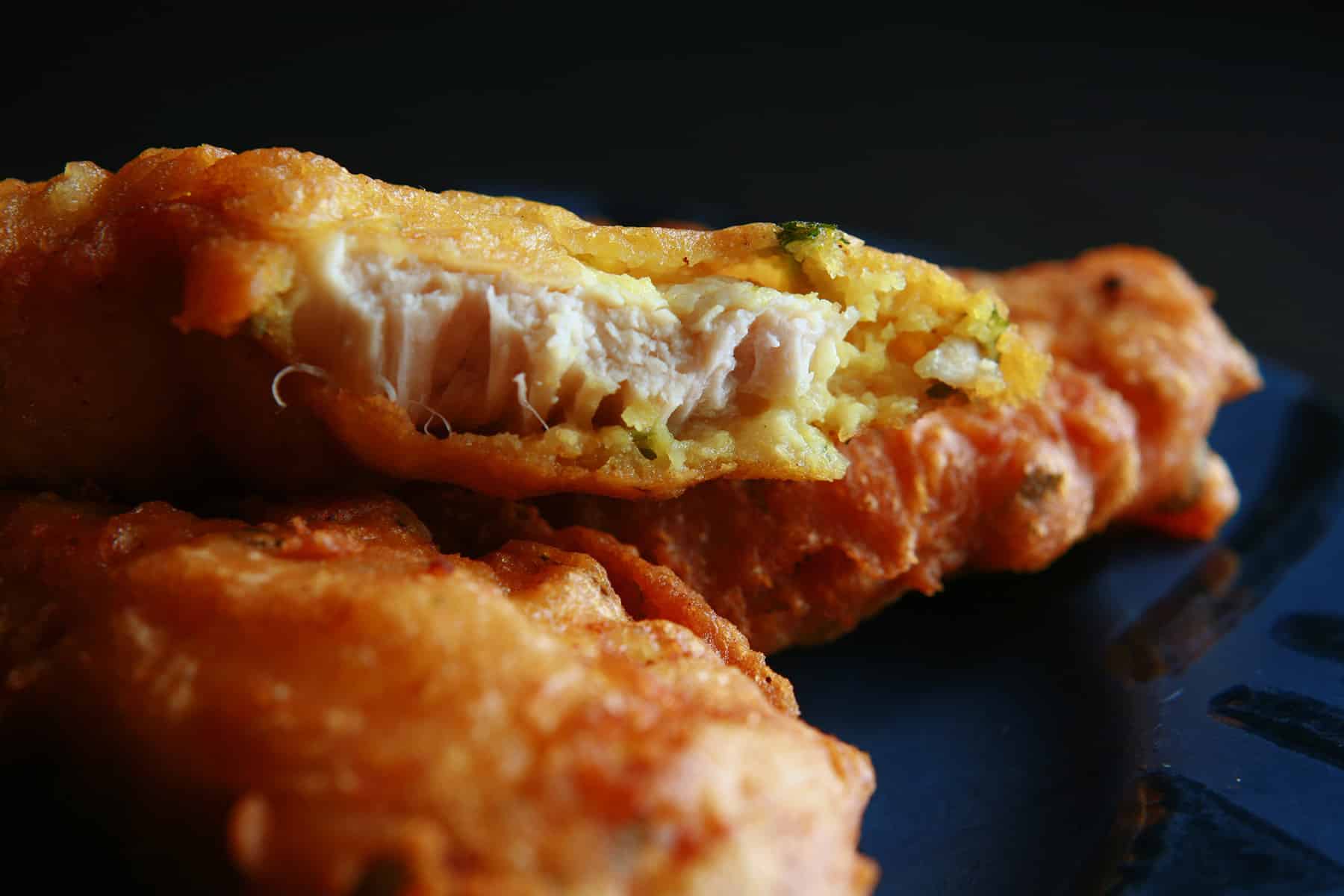 Several chicken pakoras on a blue plate.