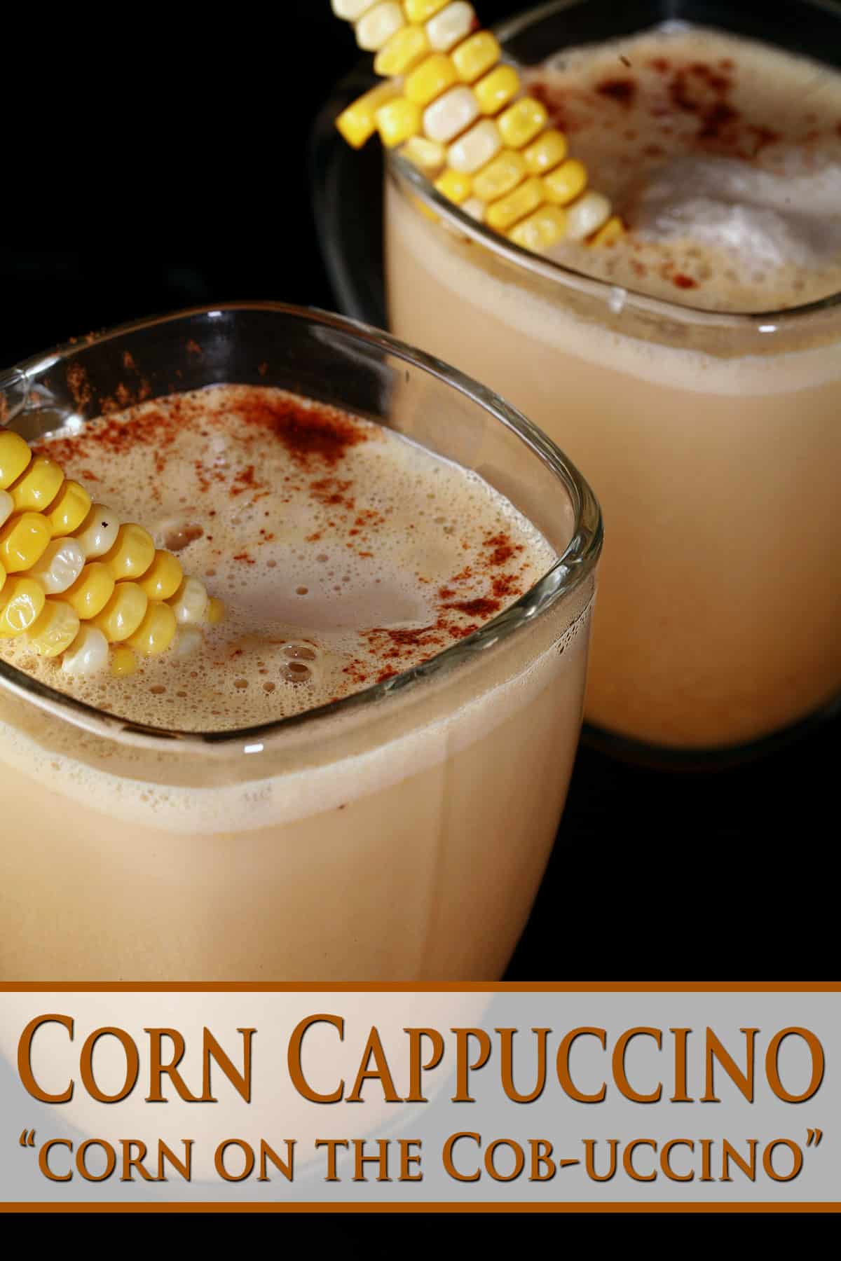 2 glass mugs of con cappuccino, garnished with narrow lengths of corn on the cob.