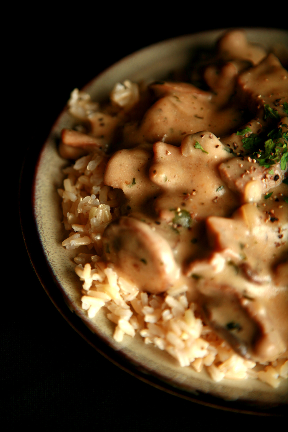 A plate of gluten-free beef stroganoff over rice.