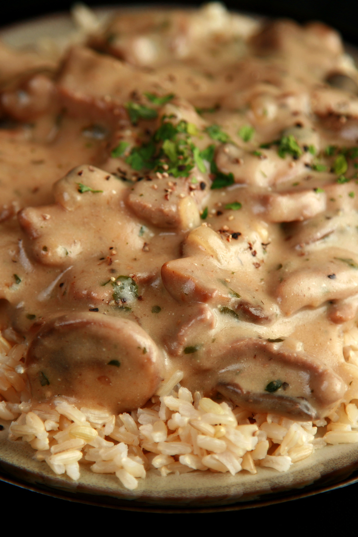 A plate of gluten-free beef stroganoff over rice.