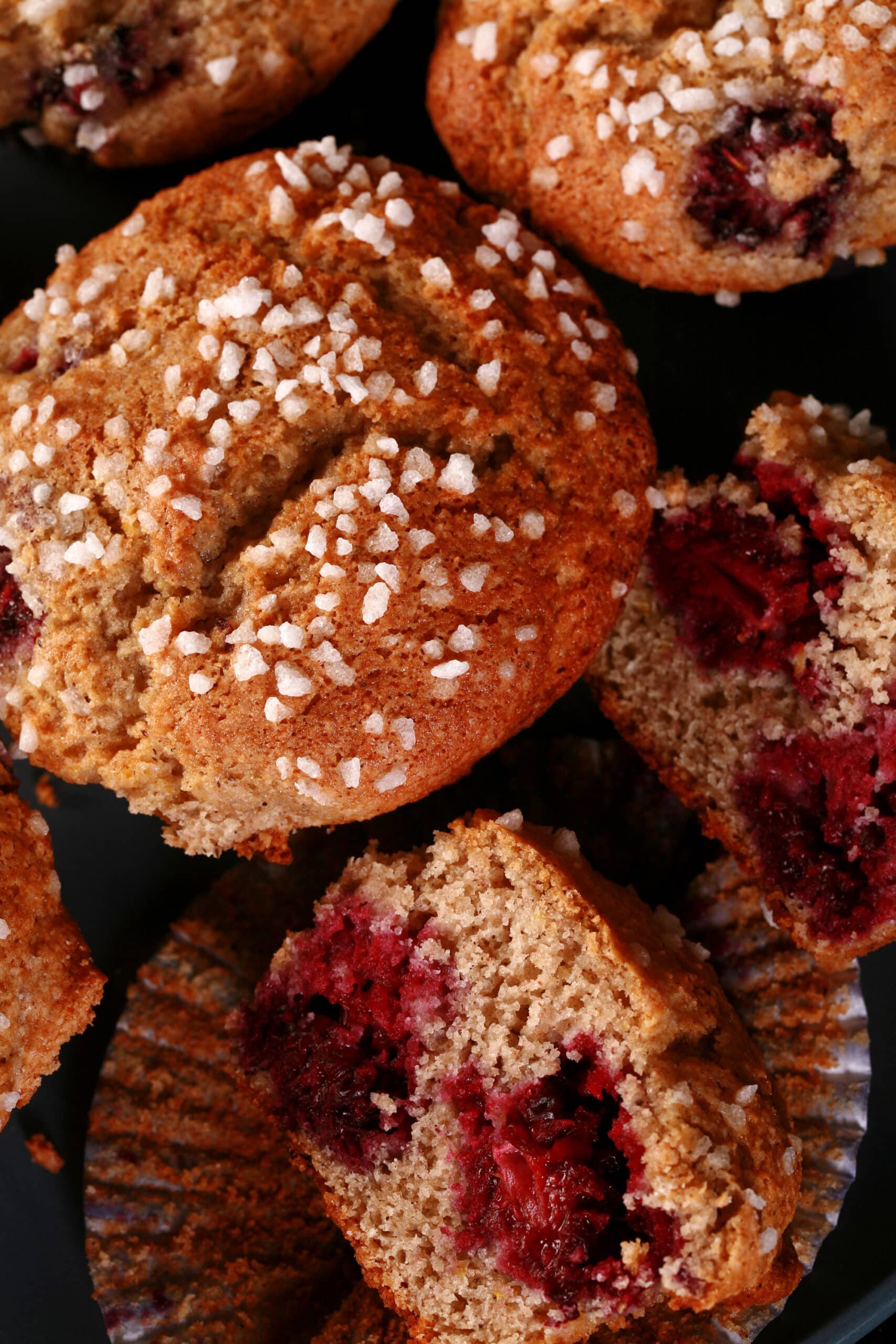 A plate of sugar crusted gluten-free blackberry muffins.