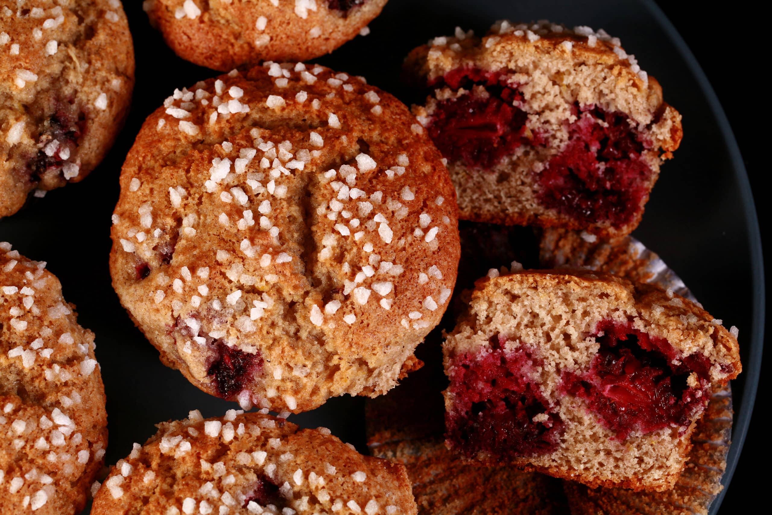 A plate of sugar crusted gluten free blackberry muffins.