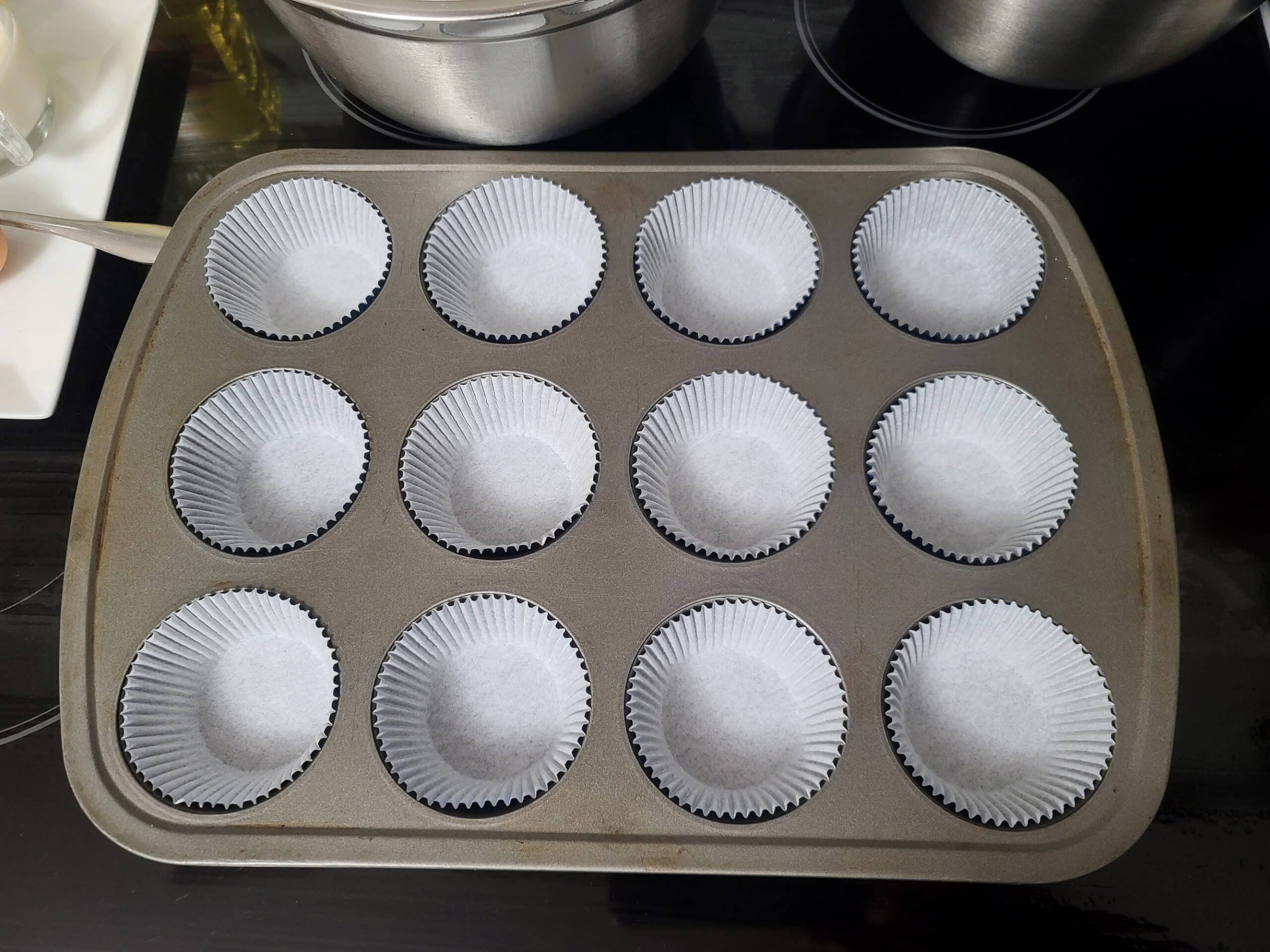 A muffin pan lined with cupcake liners.