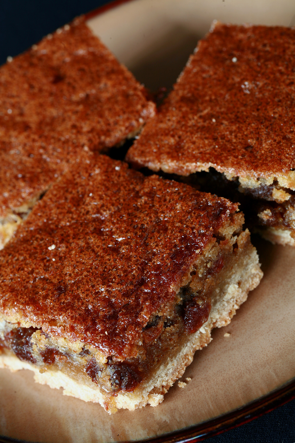 Close up view of a plate of gluten free buttertart bars.