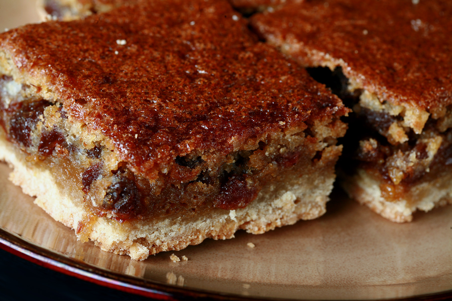 Close up view of a plate of gluten free buttertart bars.