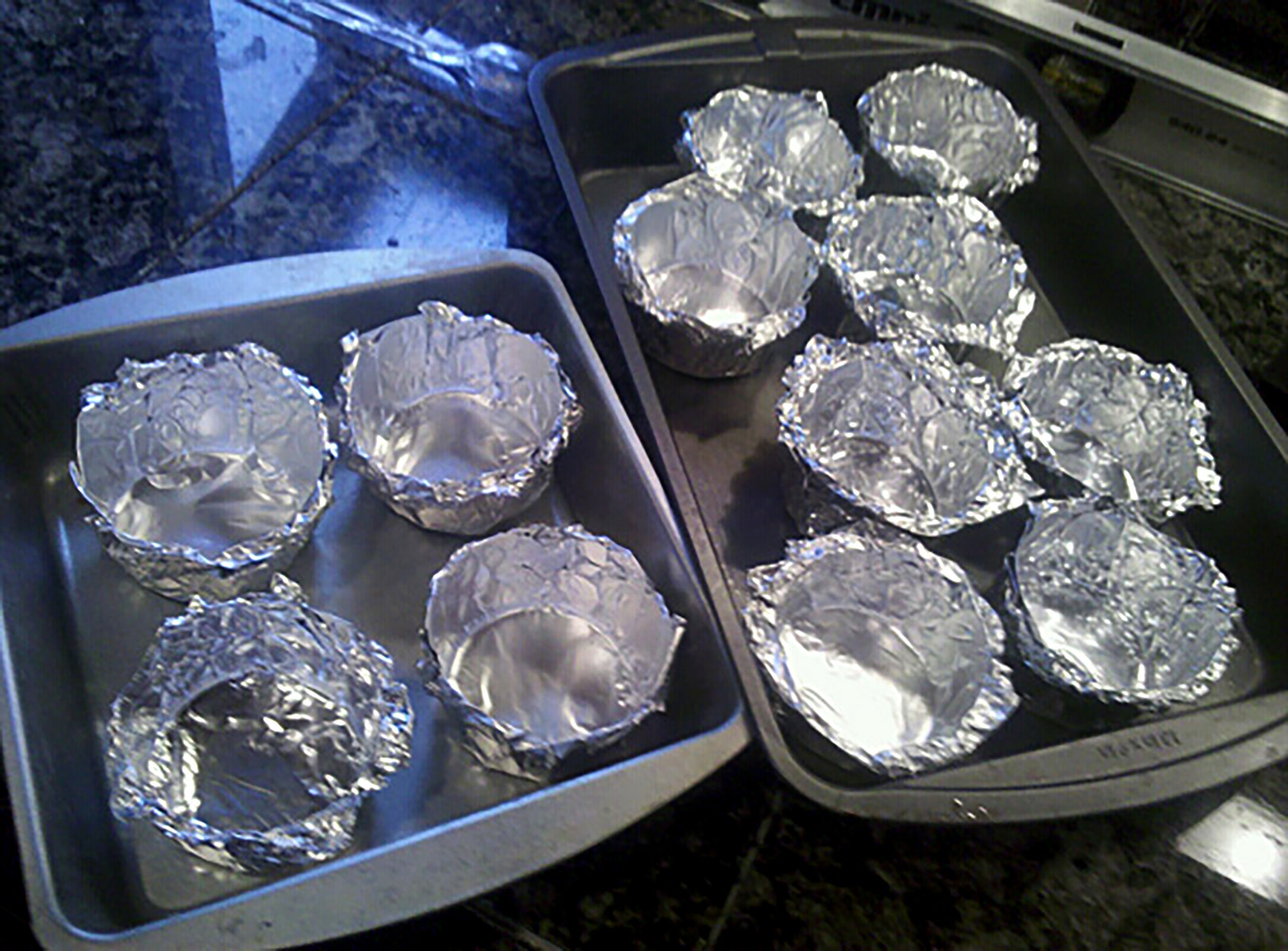 Homemade foil cuts, arranged in baking pans.