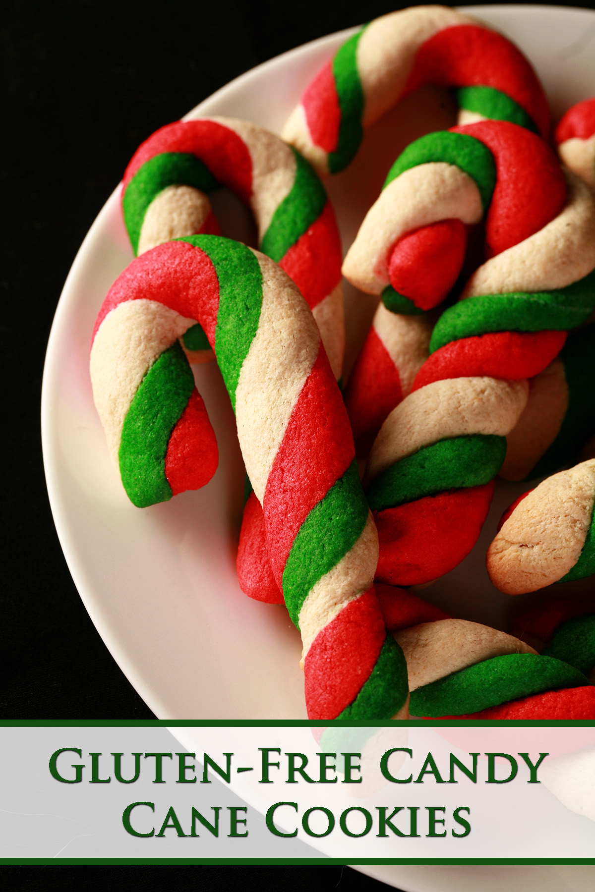 Gluten-Free Candy Cane cookies - candy cane shaped cookies, made from lengths of red, green, and white twisted dough - on a plate.