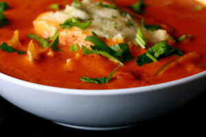 A bowl of gluten-free creamy creole soup with cornmeal dumplings.