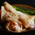 2 Gluten free seafood crepes with asparagus spears on the side.