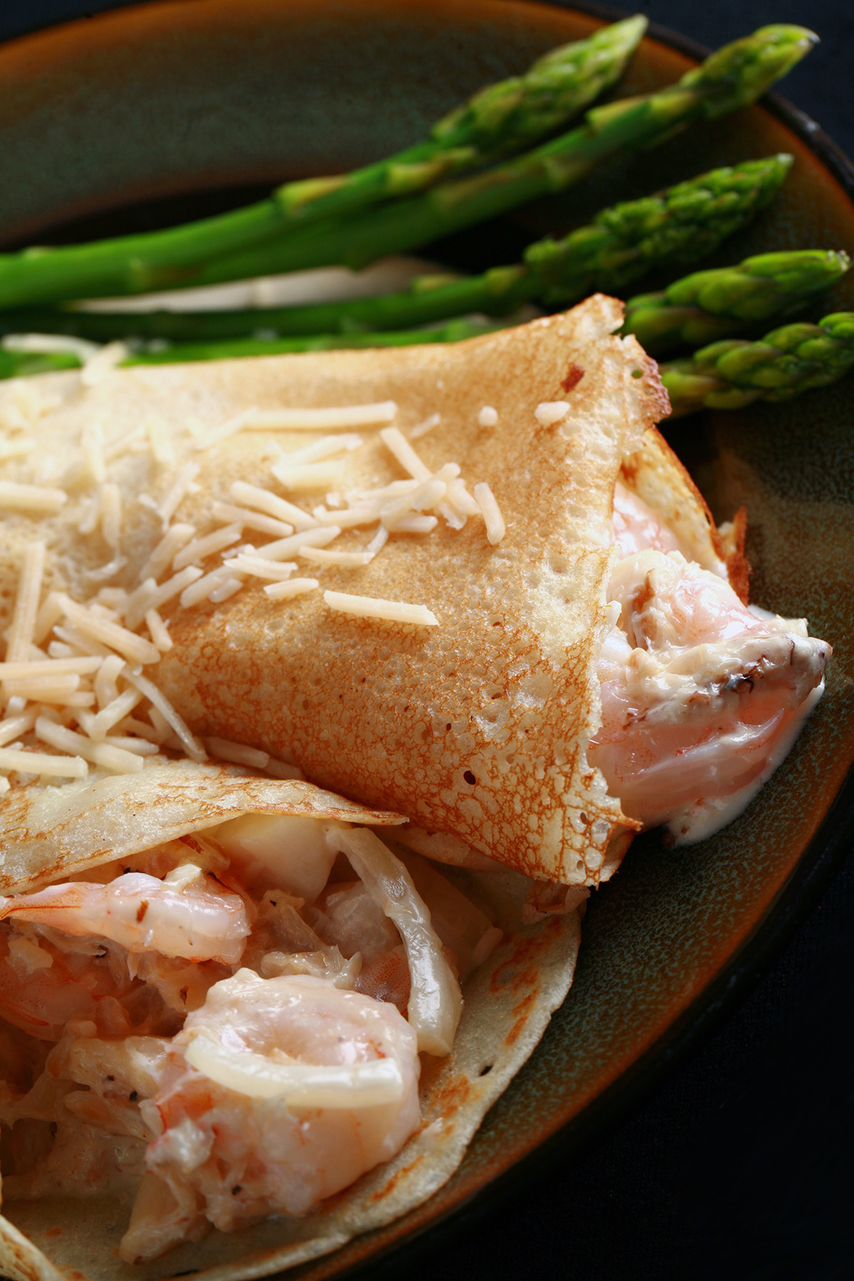 Two gluten free crepes stuffed with seafood and white wine sauce.