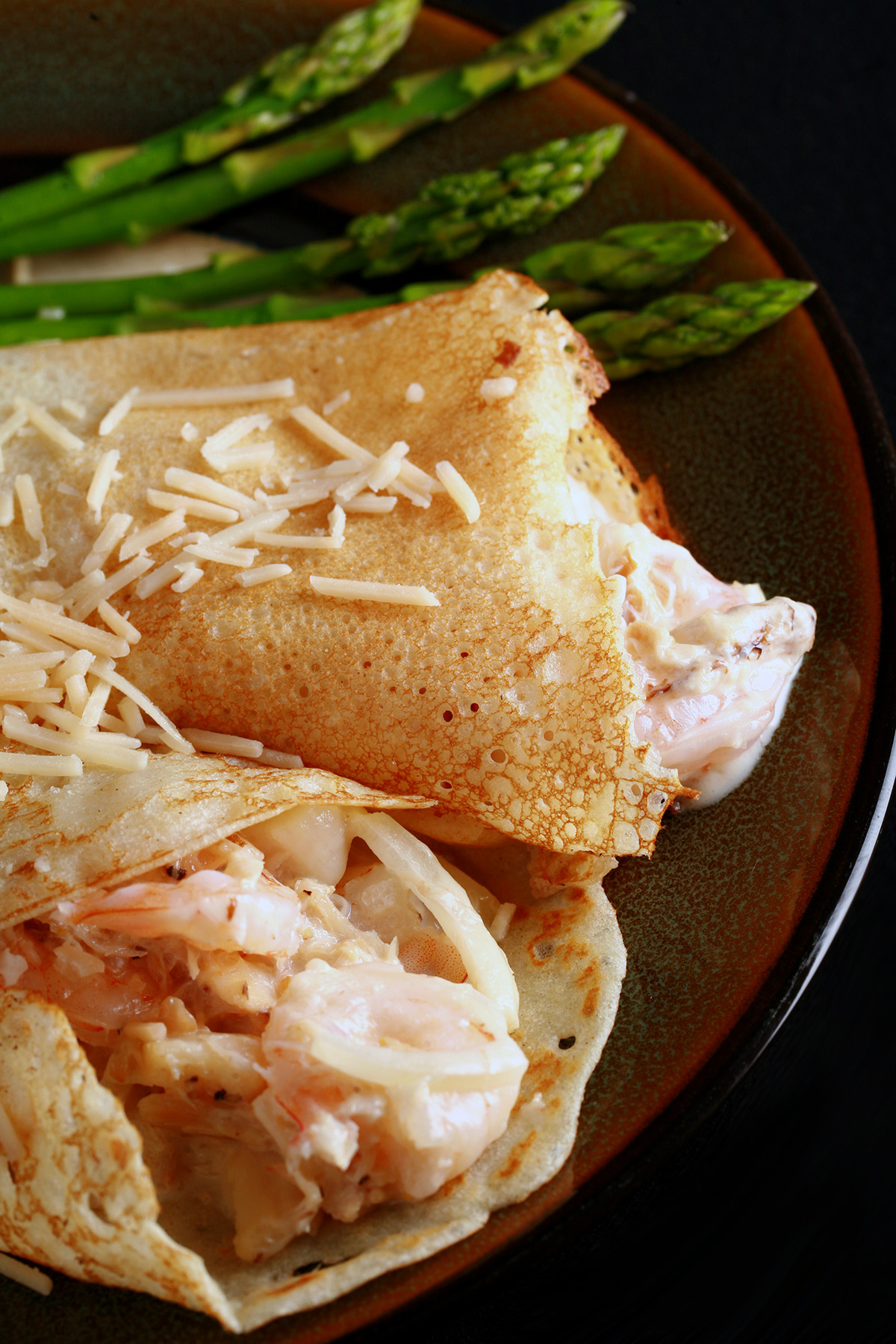 Two gluten free crepes stuffed with seafood and white wine sauce.