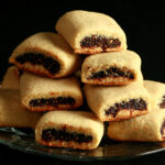 A small glass plate piled high with gluten-free fig newtons.