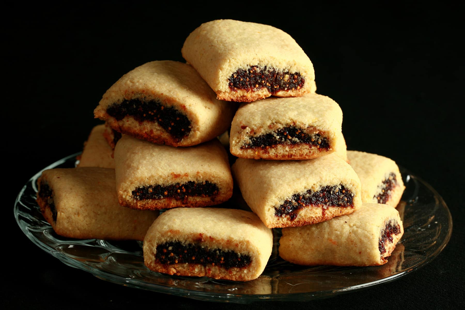A small glass plate piled high with gluten-free fig newtons.