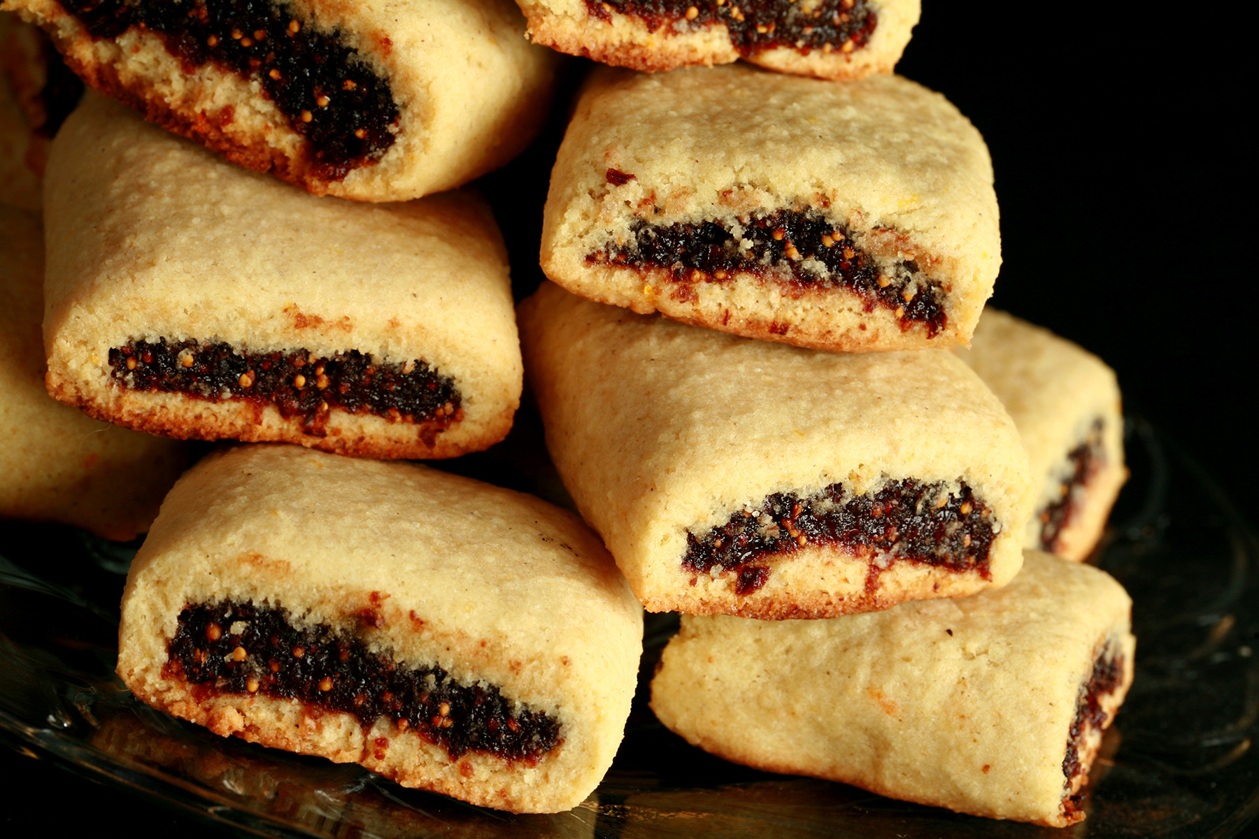 A small glass plate piled high with gluten-free fig newtons.