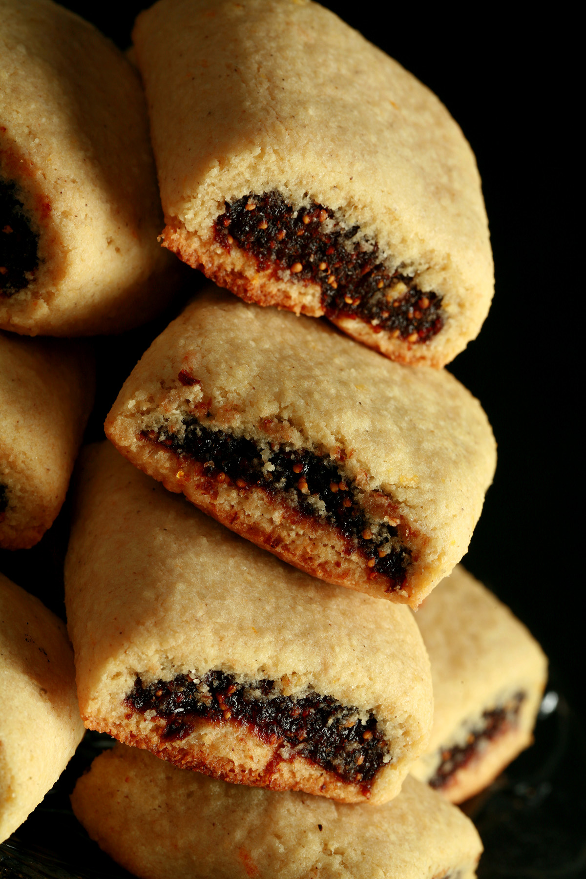 A small glass plate piled high with gluten-free fig newton cookies.