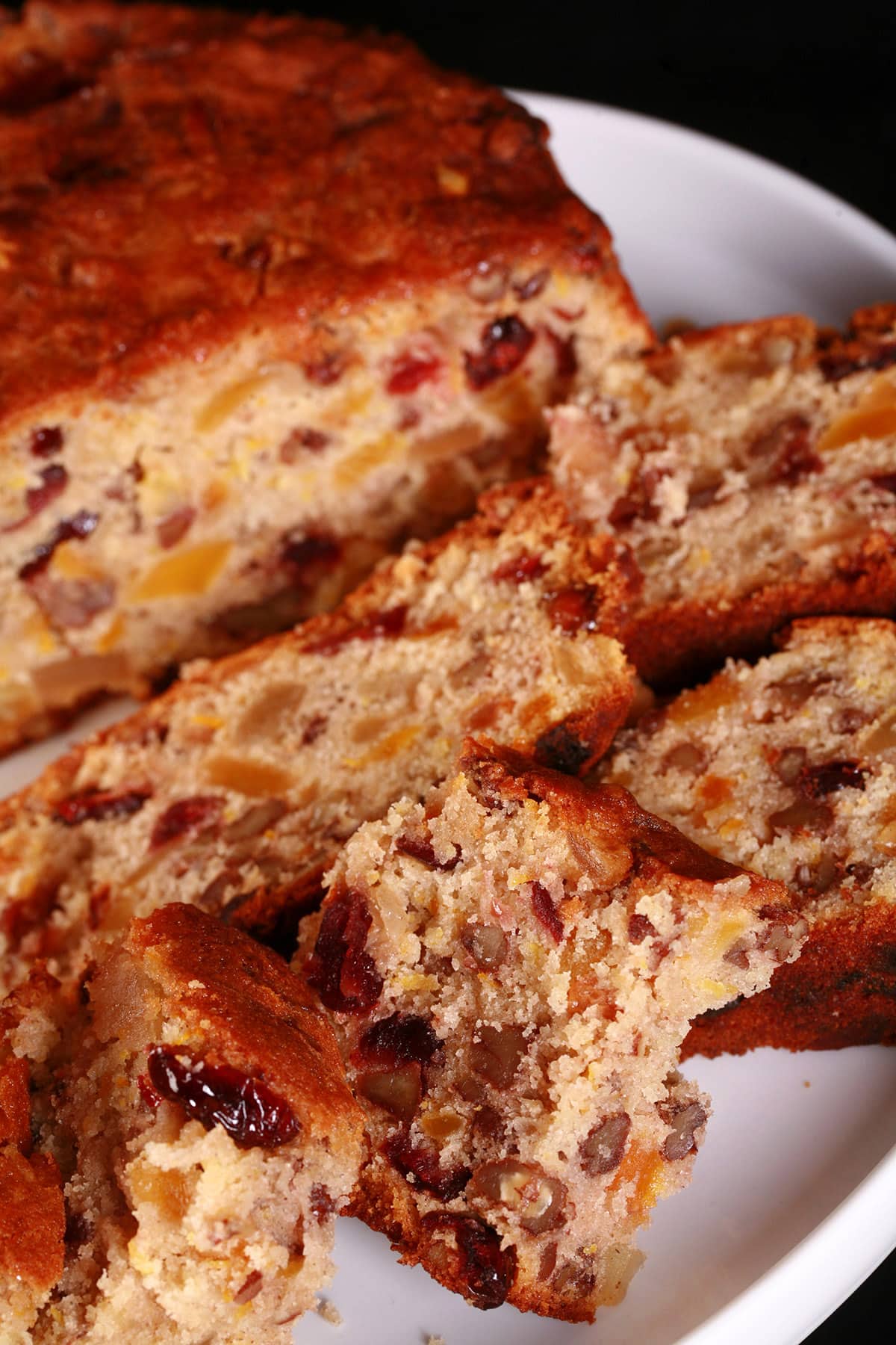 A sliced up gluten free fruitcake.