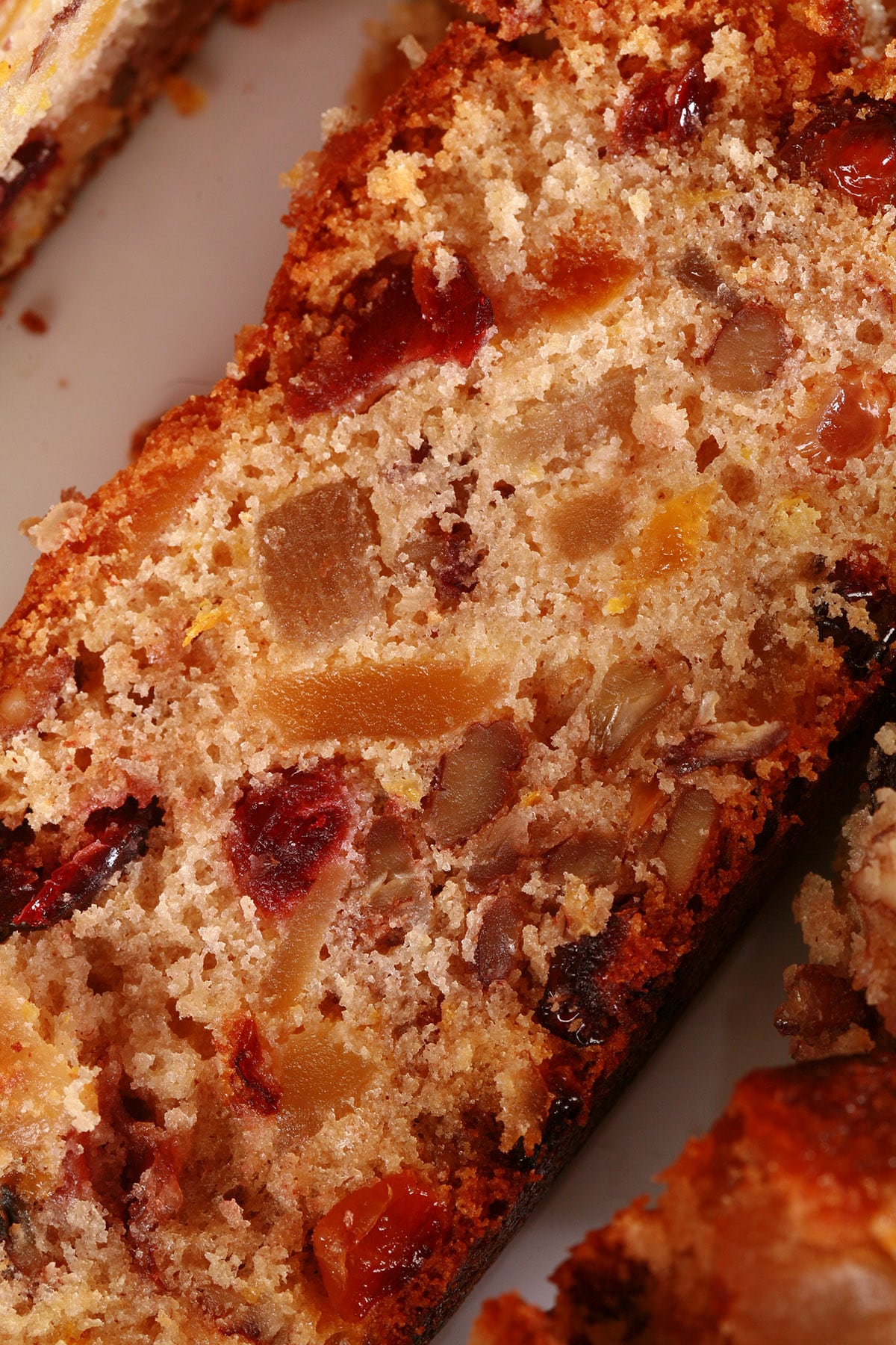 A sliced up gluten free fruit cake.