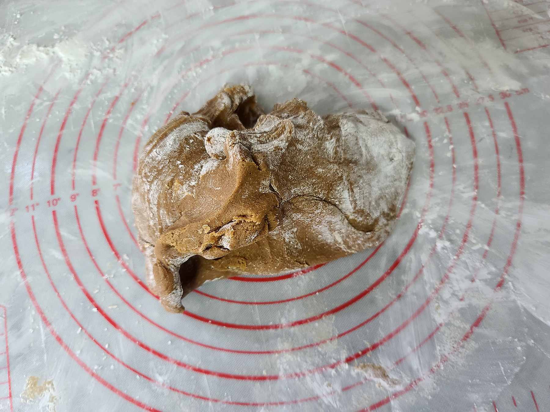 A mound of cornstarch covered gluten-free gingerbread dough.
