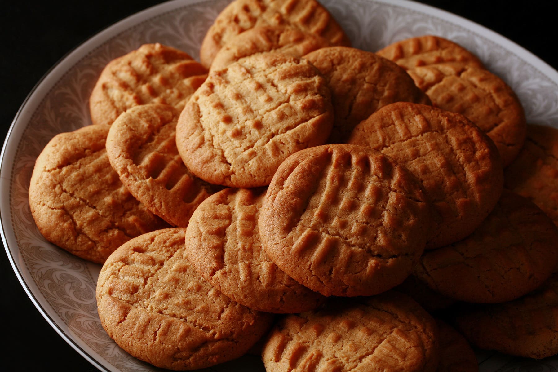 A plate of soft and chewy gluten free peanut butter cookies.