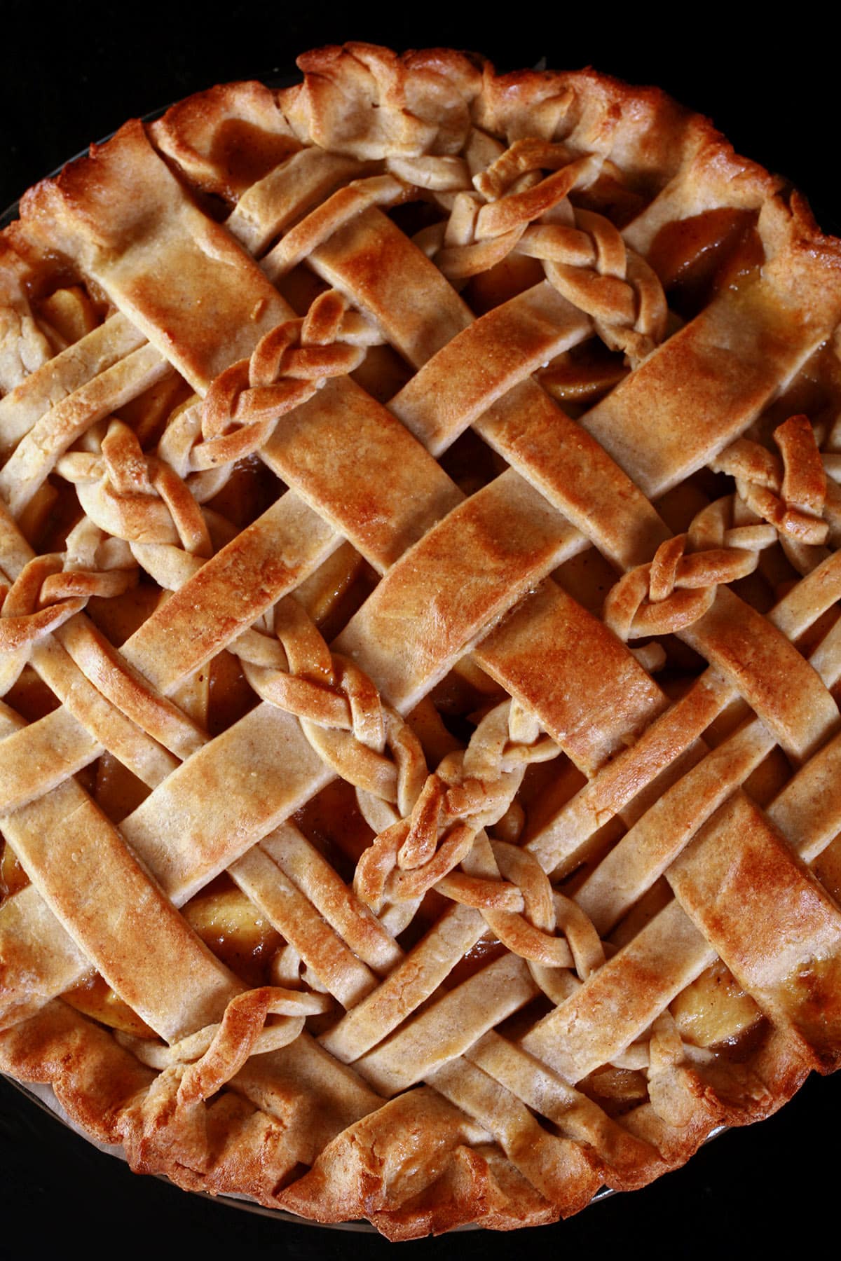 A close up view of a lattice topped pie, made with a gluten free pie crust.