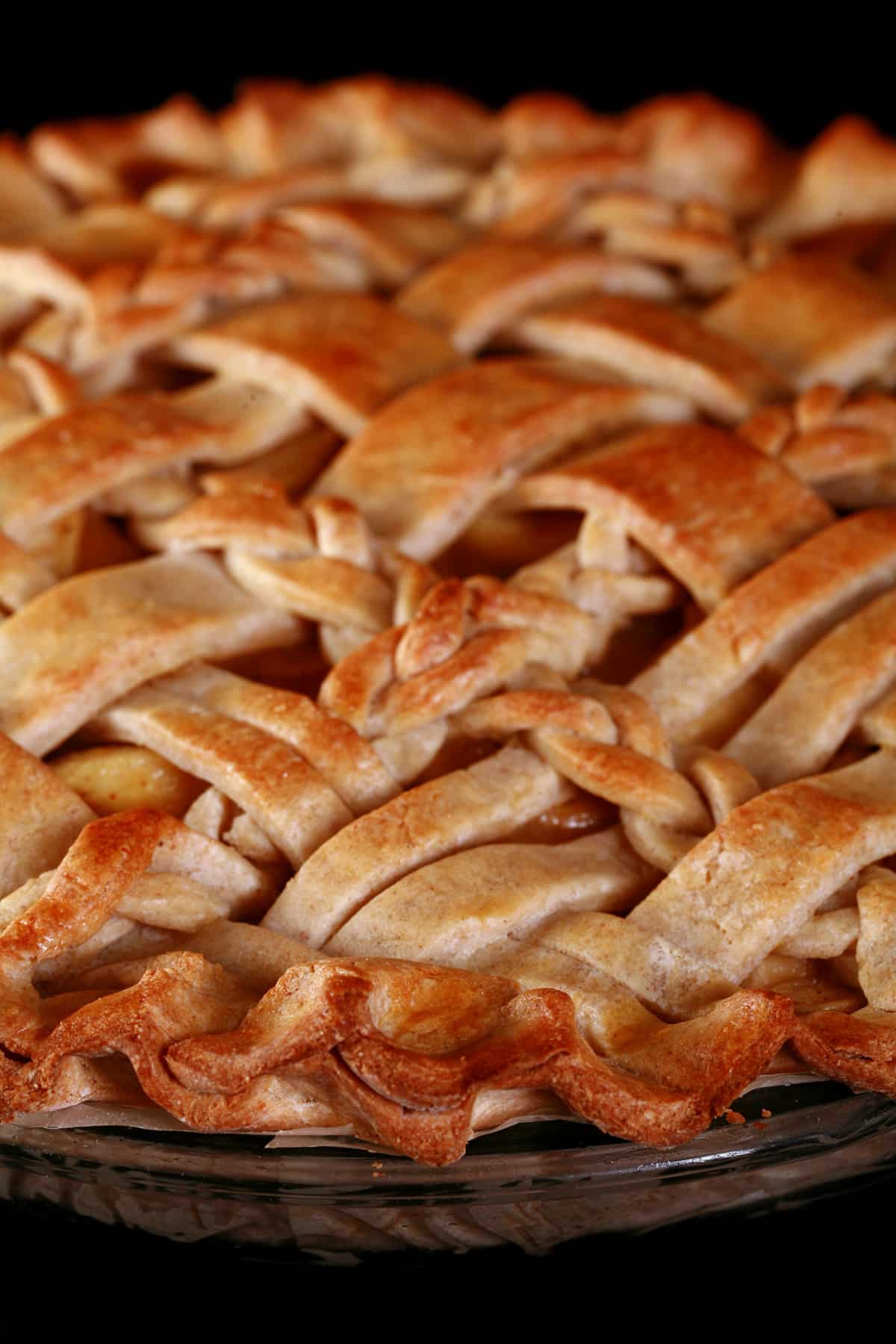 A close up view of a lattice topped pie, made with a gluten free pie crust.