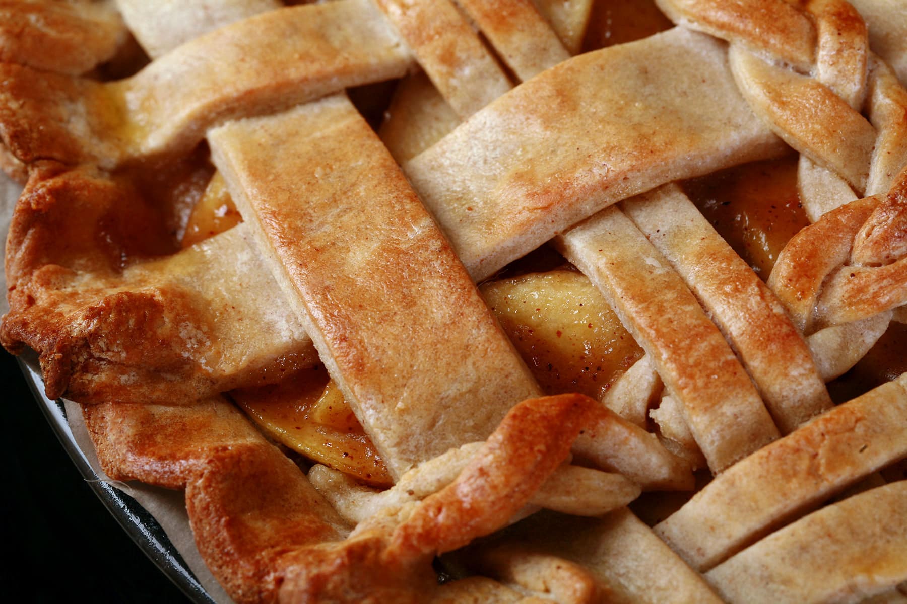 A close up view of a lattice topped pie, made with a gluten free pie crust.