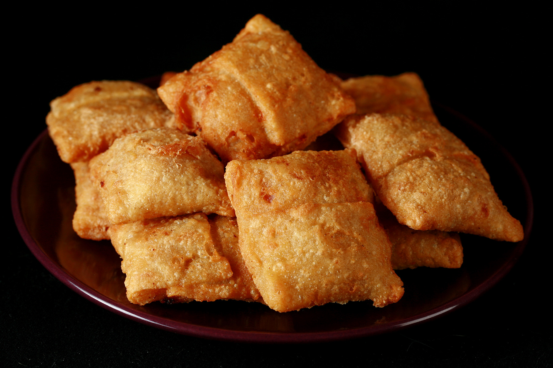 A plate with a pile of gluten-free pizza bites.