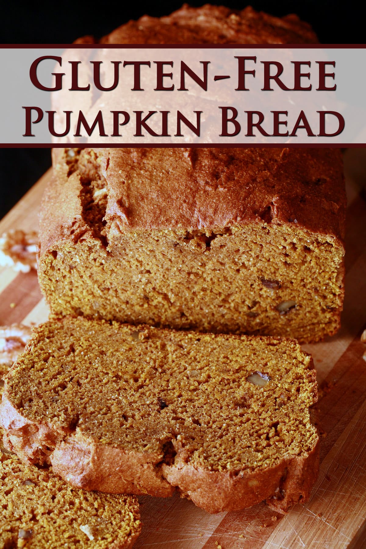 A loaf of gluten free pumpkin spice bread on a cutting board, sliced.