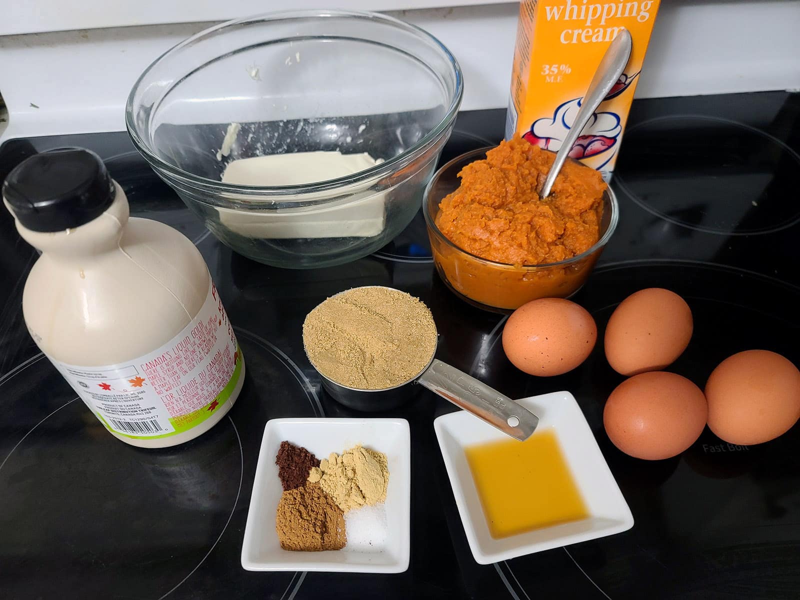 All of the pumpkin pie ingredients, laid out on a stovetop.