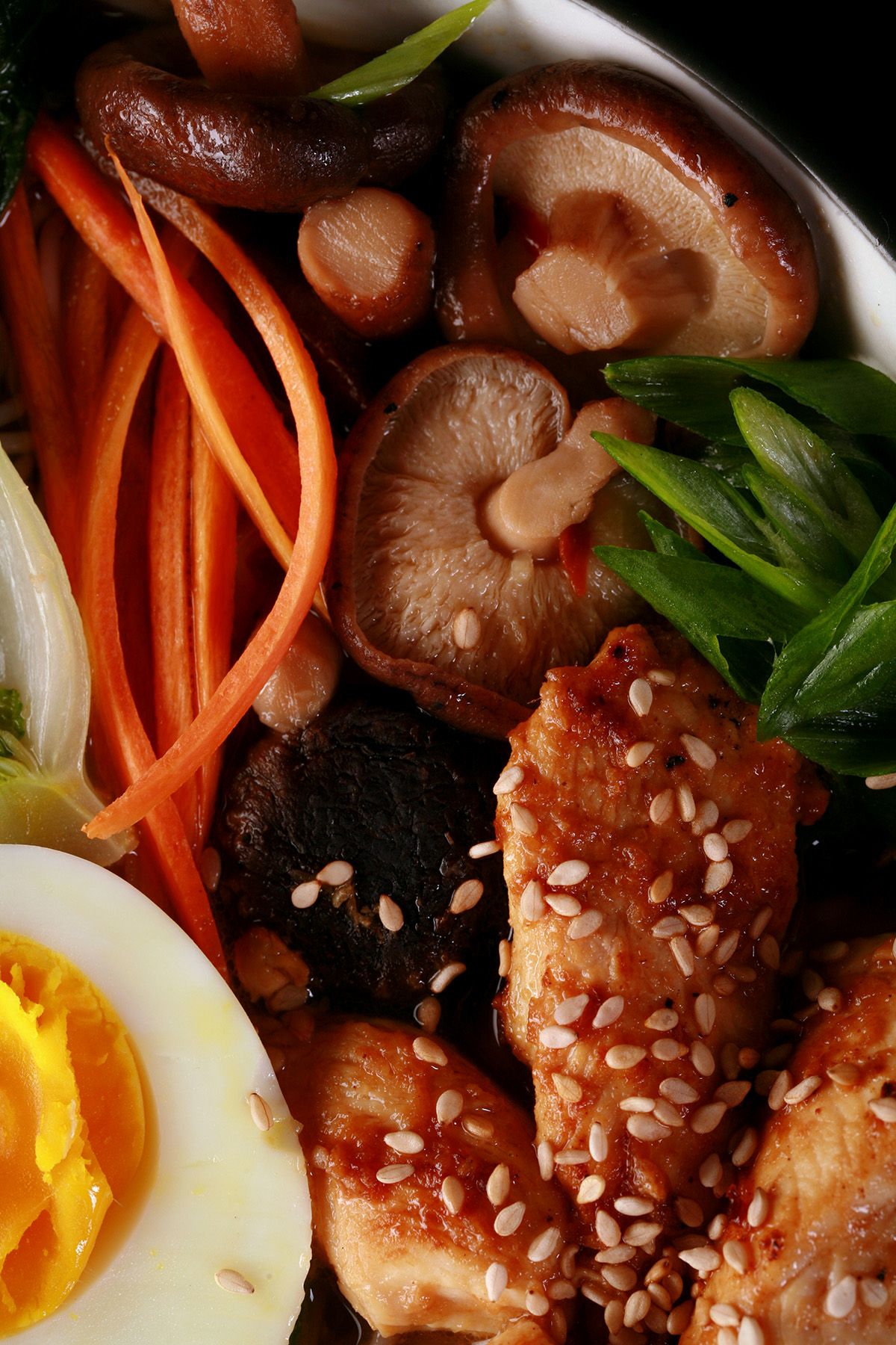 A bowl of gluten free ramen, with chicken and vegetables.