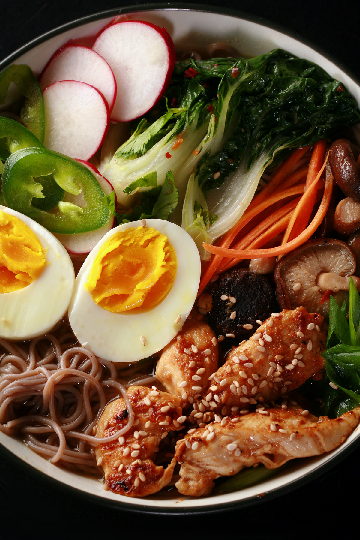 A bowl of gluten-free ramen, with chicken and vegetables.