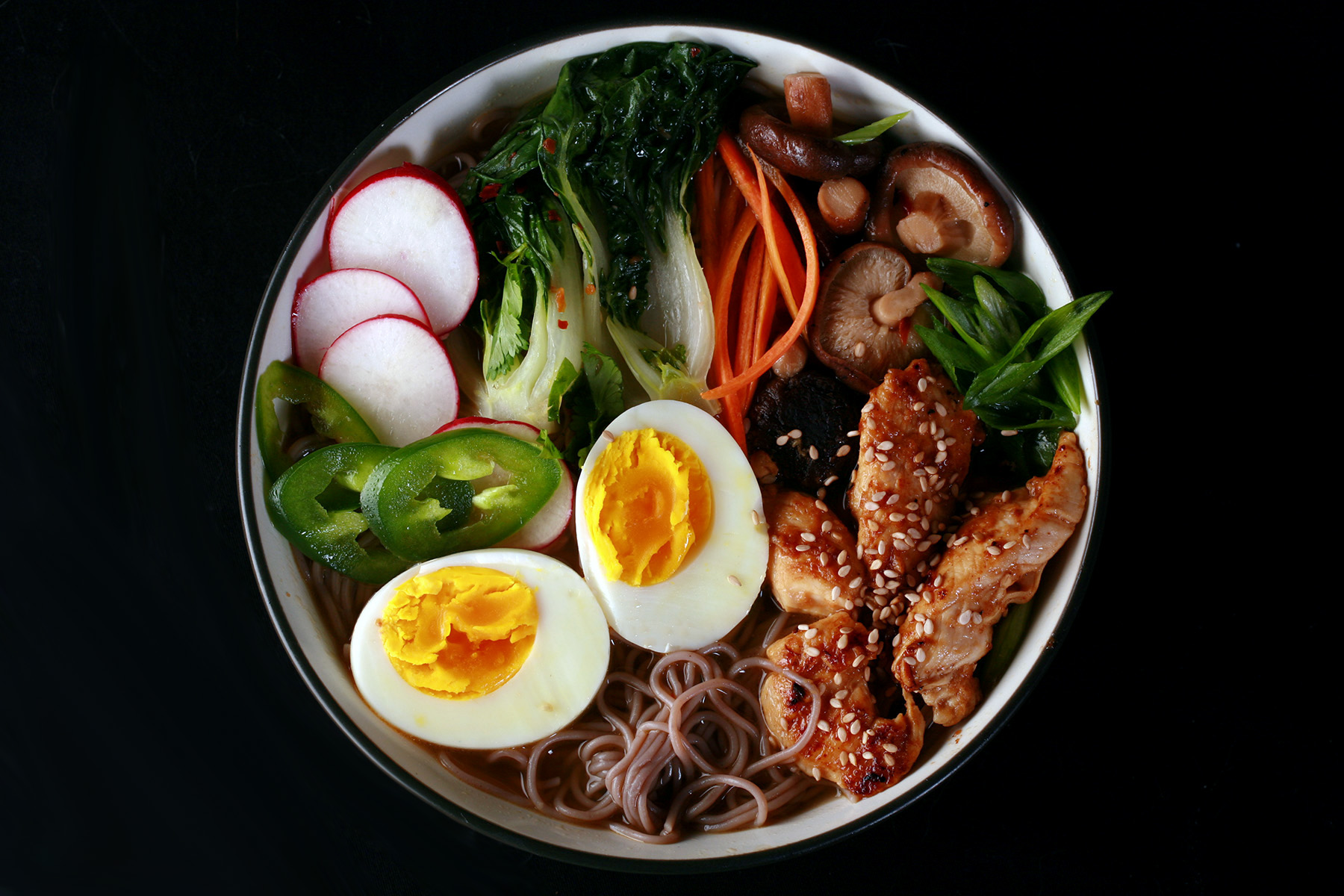 A bowl of gluten-free ramen, with chicken and vegetables.