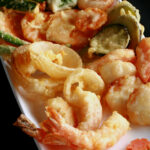 A tray of gluten-free tempura shrimp and vegetables.