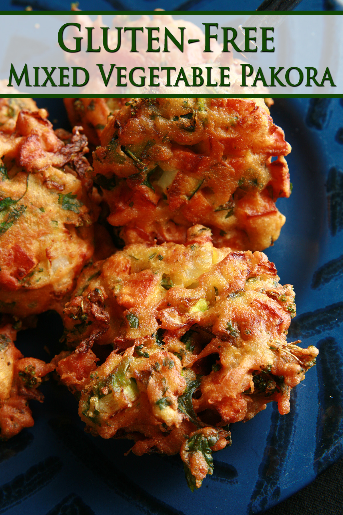 Several Mixed veggie pakora, on a blue plate.