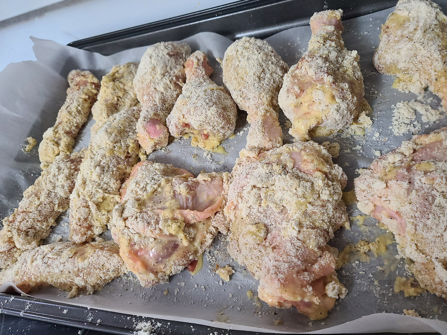 A pan of coated gluten free chicken, ready to be deep fried.