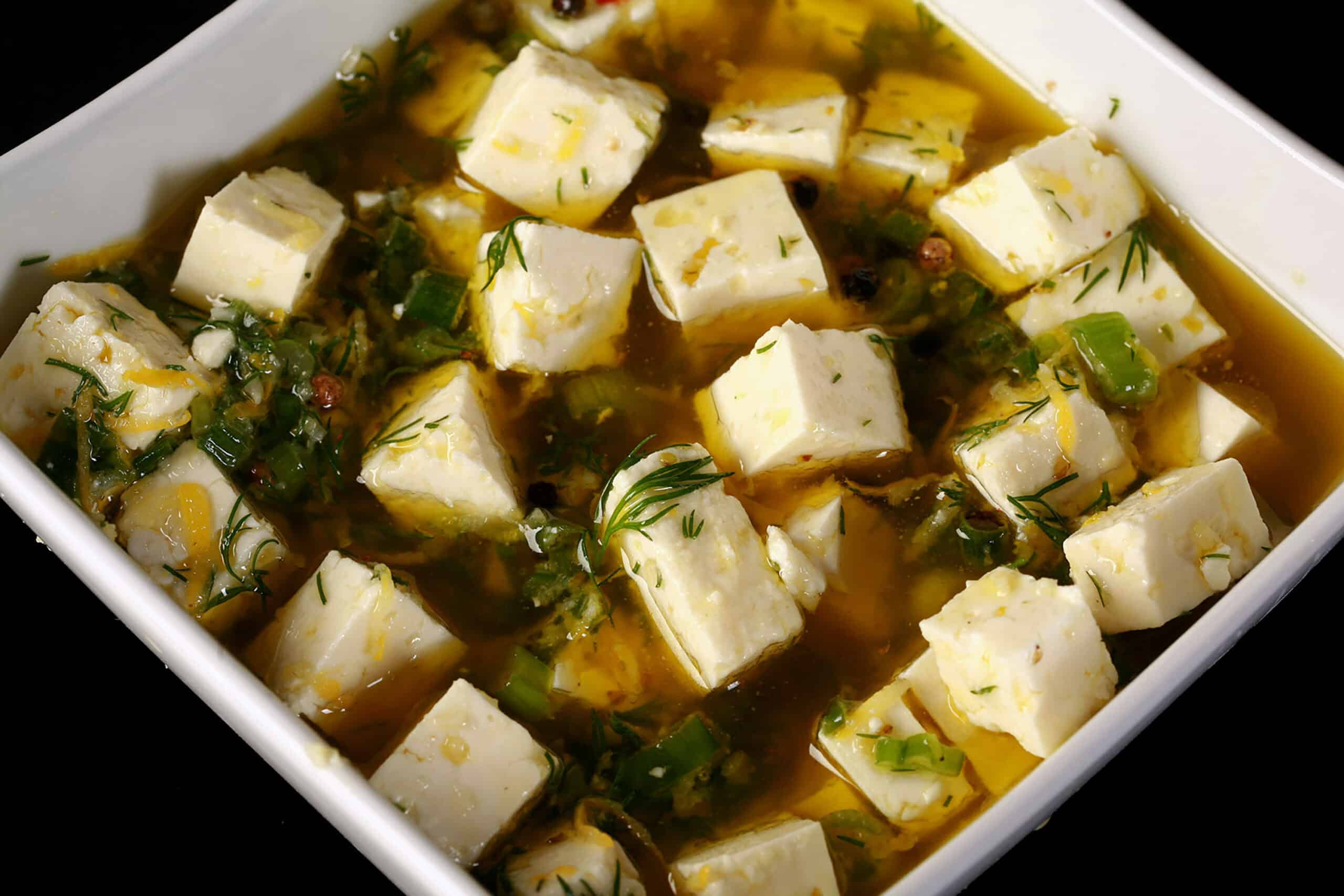 A bowl of lemon herb marinated feta.