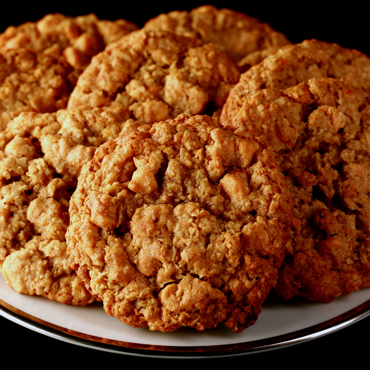 Close up photo of a plate of gluten-free oatmeal cookies with visible butterscotch chips